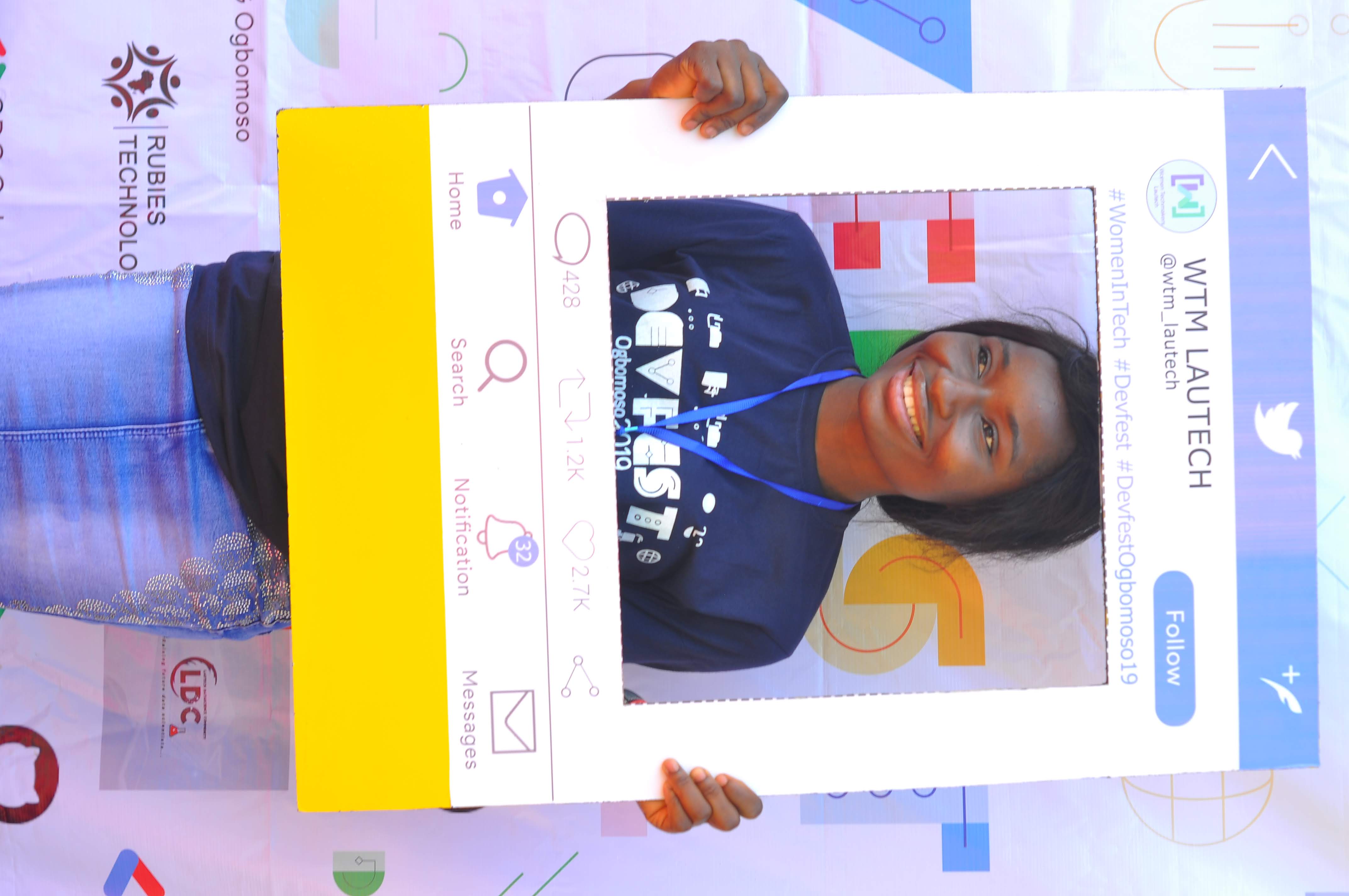 An attendee posing with a Twitter-style photo frame at DevFest Ogbomoso 2019