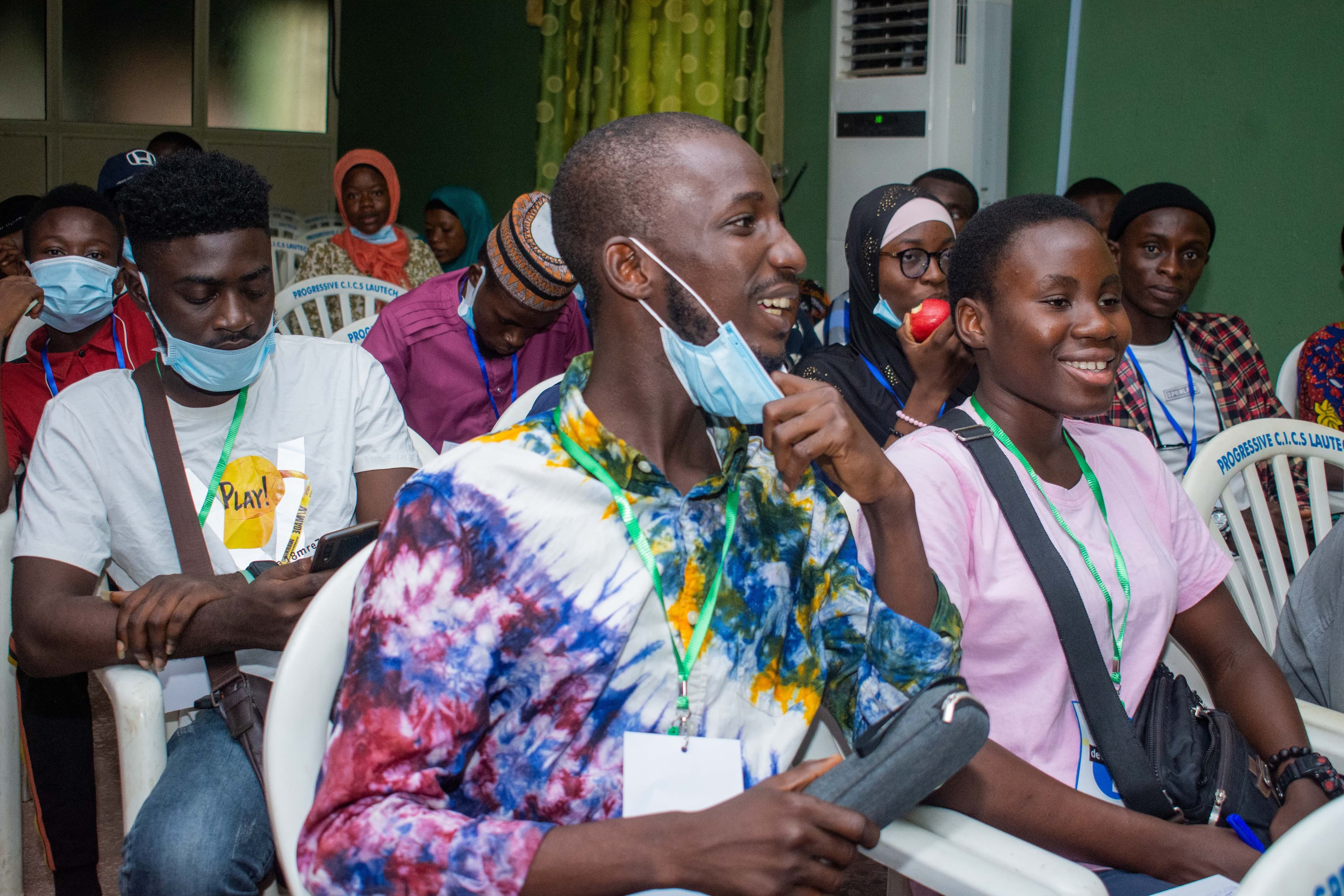 Smiling attendees seated in the audience at DevFest Ogbomoso 2021