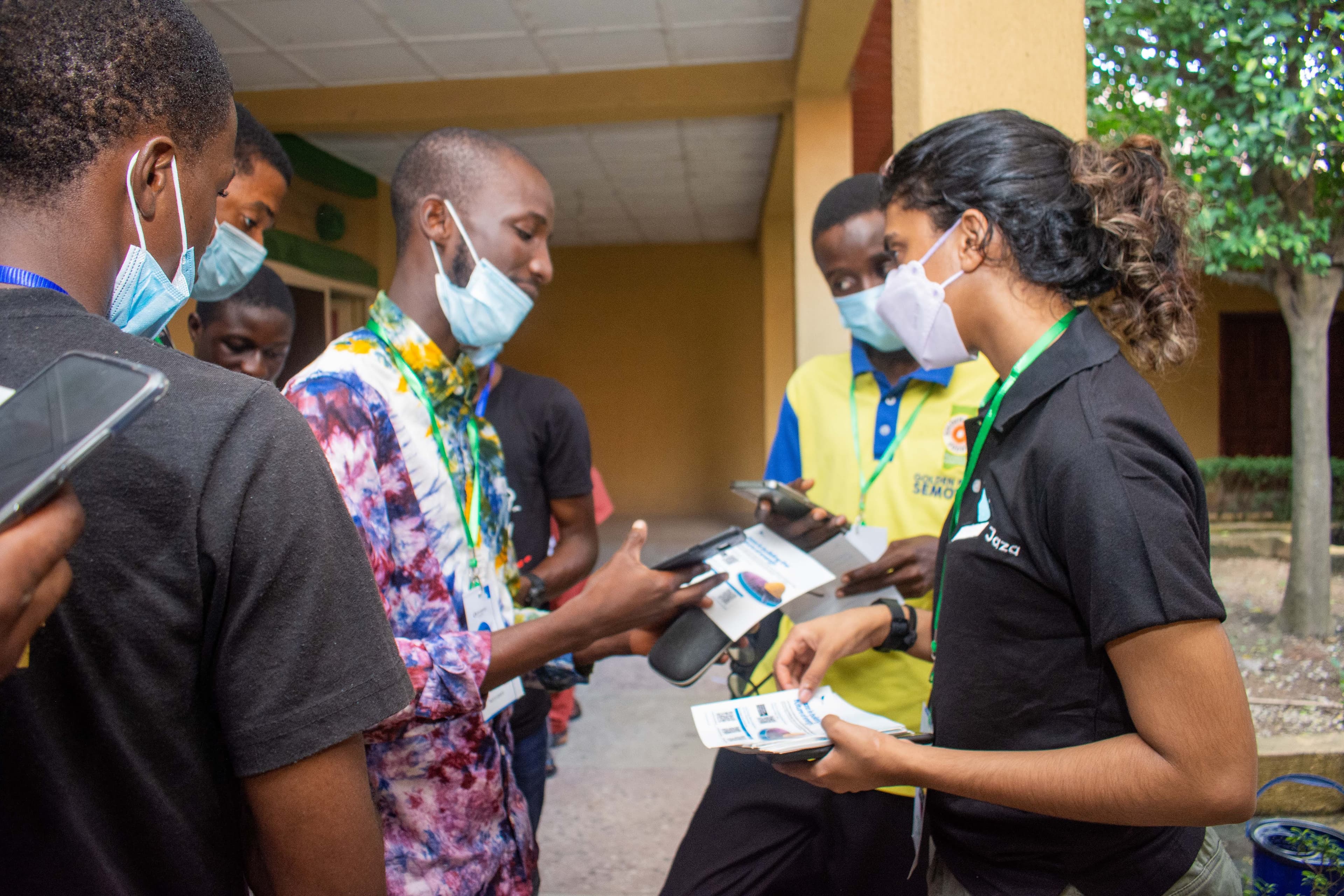Attendees with flyers and phones in a walkway at DevFest Ogbomoso 2021