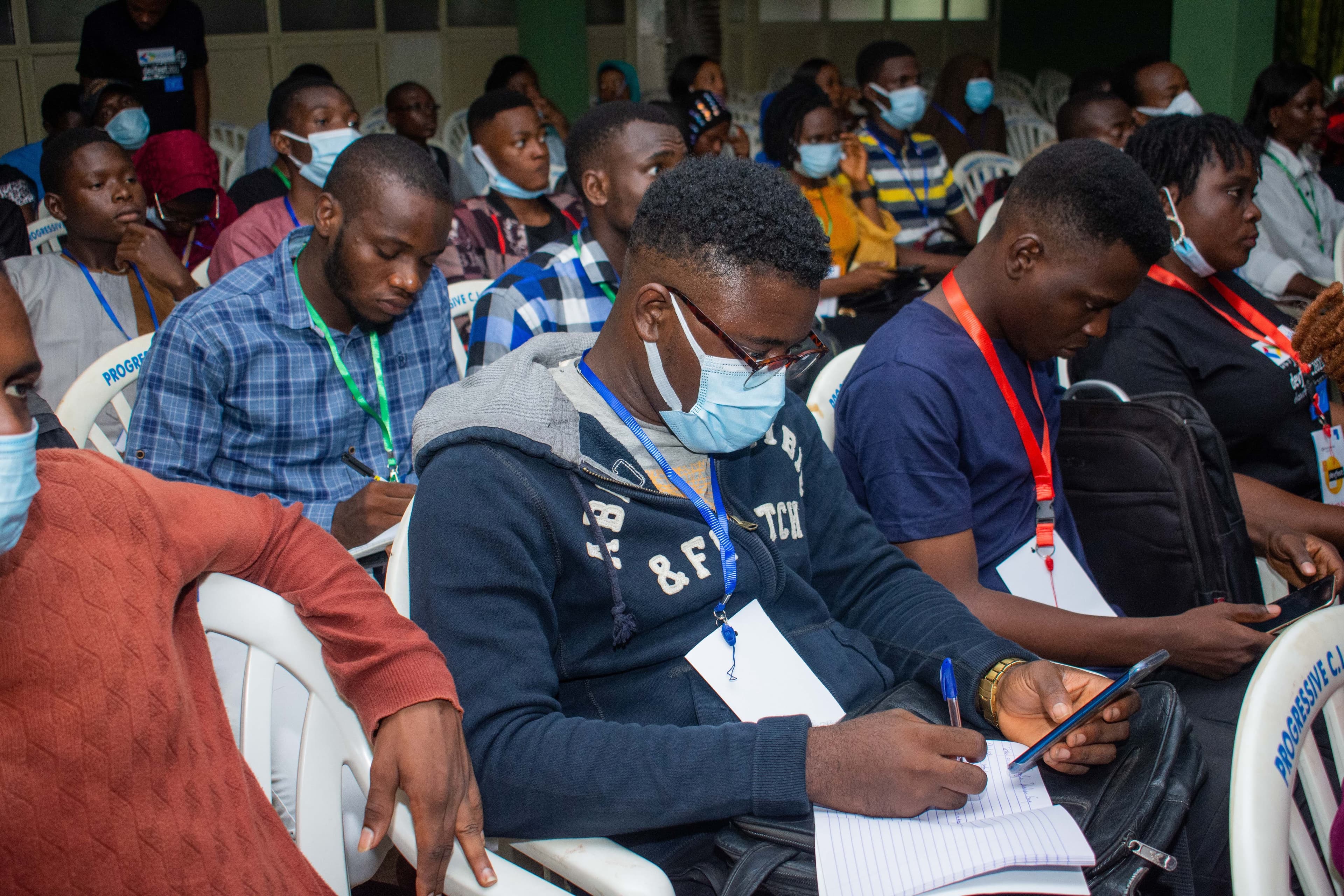 An attendee taking notes during a session at DevFest Ogbomoso 2021