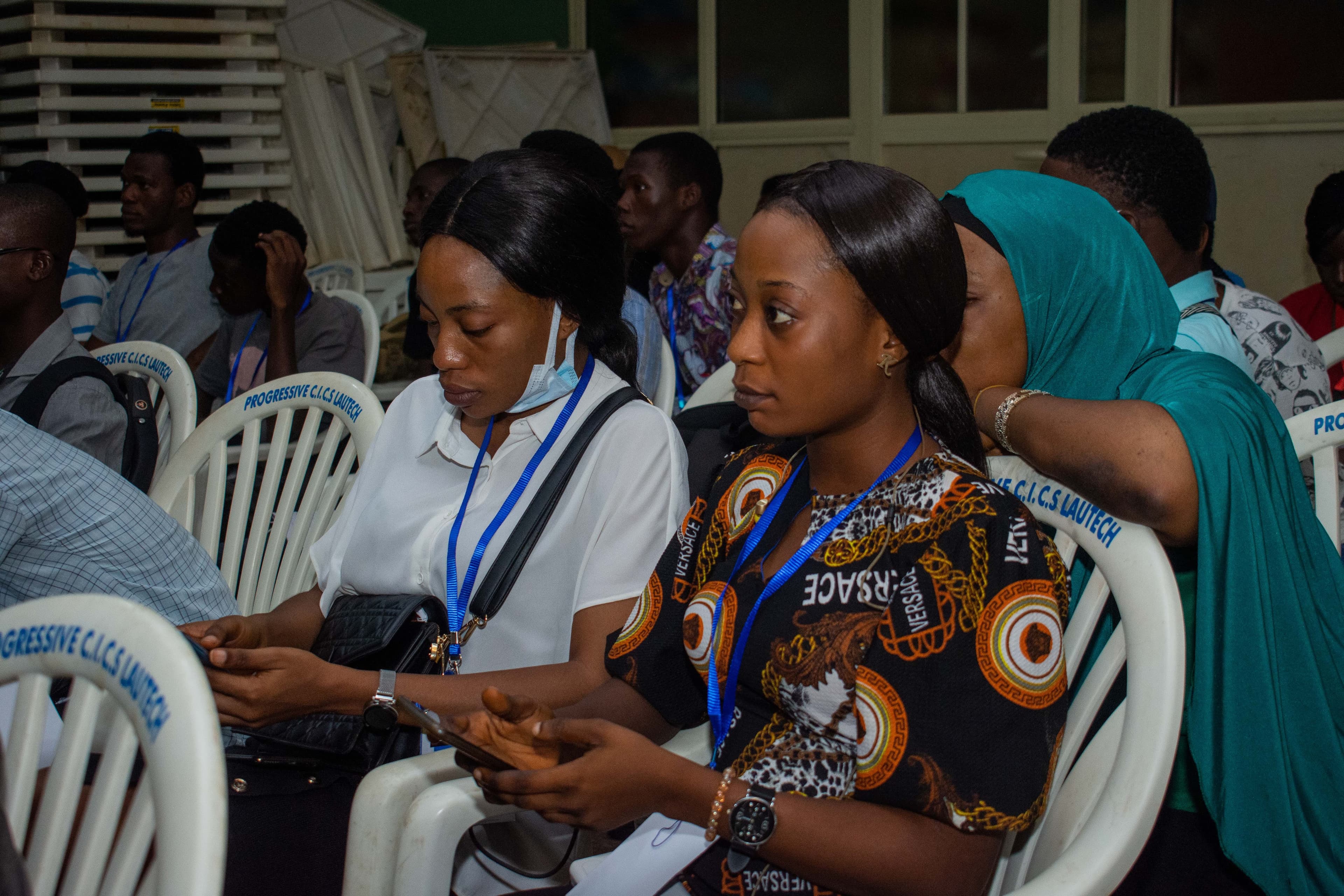 Attendees seated with their phones in the audience at DevFest Ogbomoso 2021