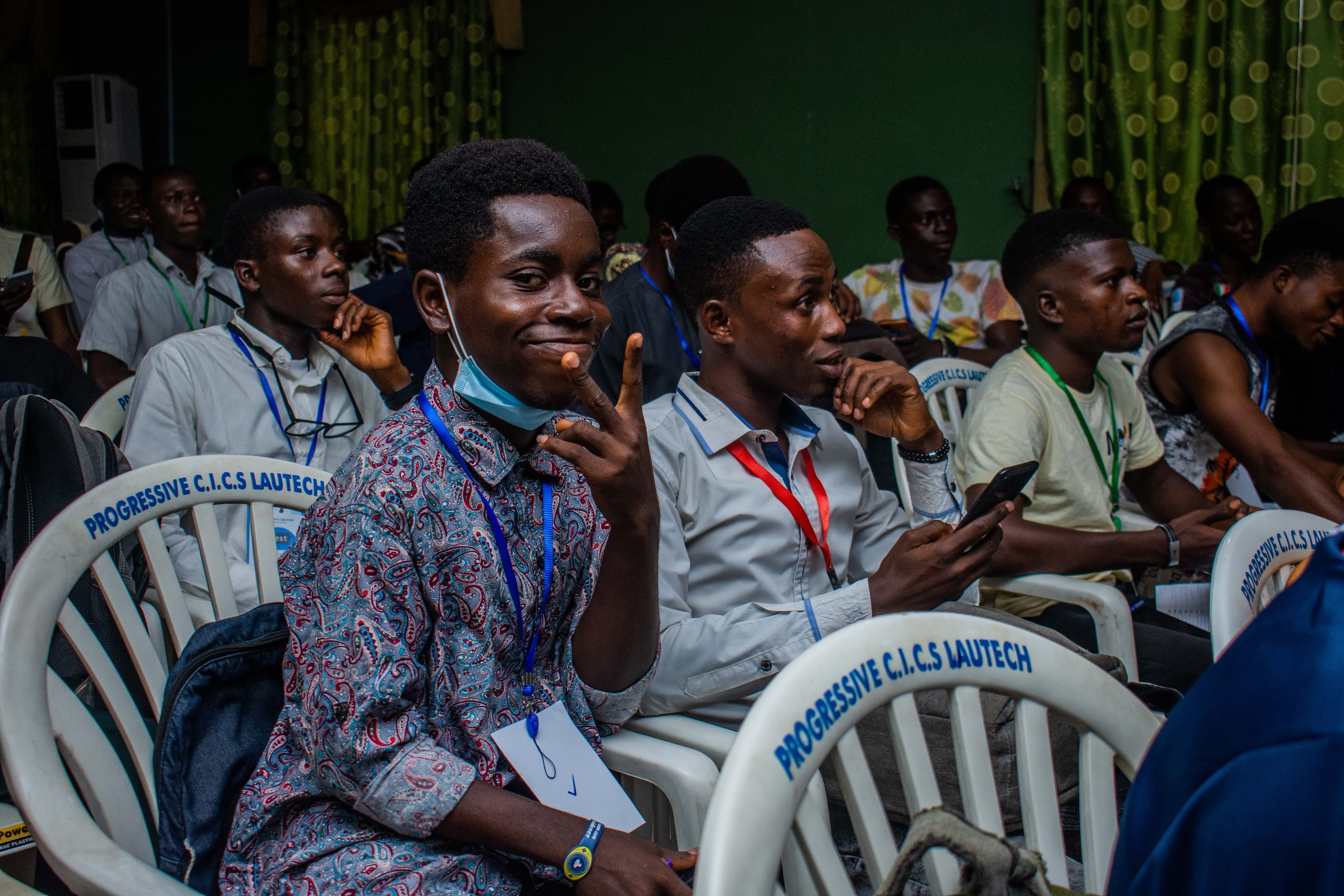 An attendee smiling in the audience at DevFest Ogbomoso 2021