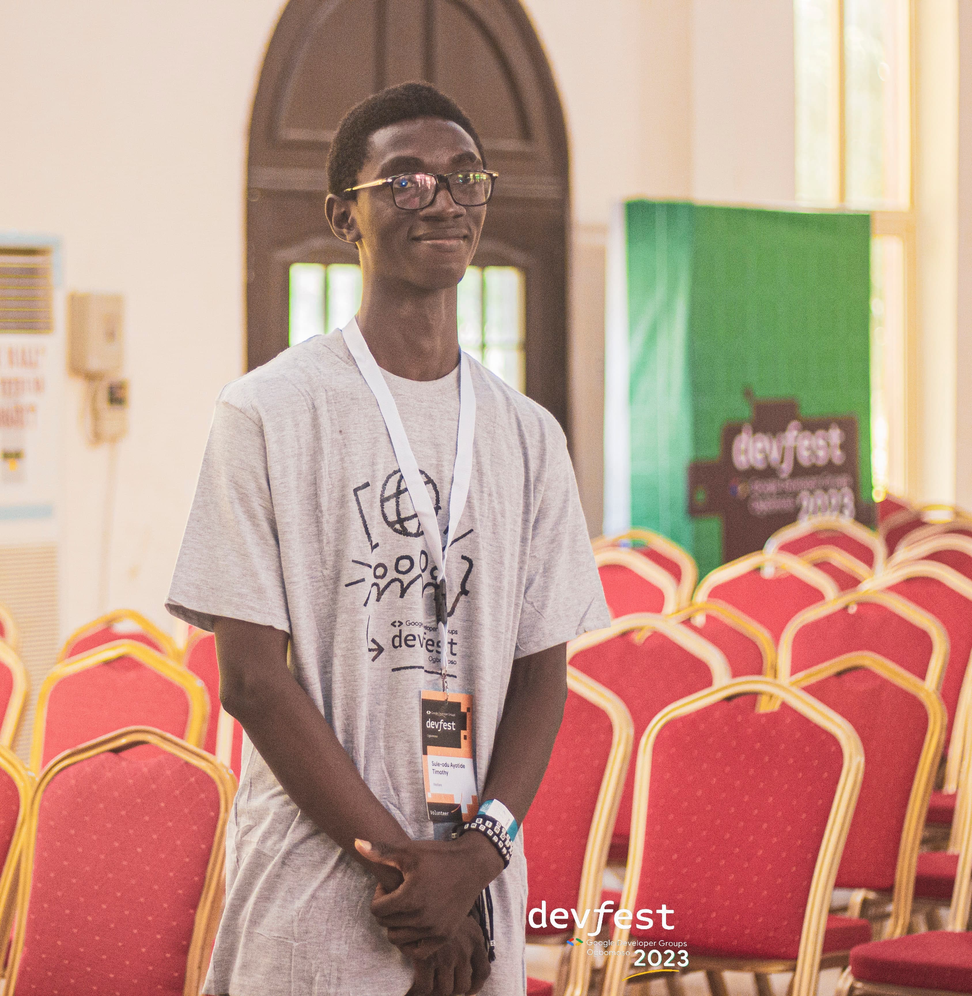 An attendee standing between rows of seats at DevFest Ogbomoso 2023