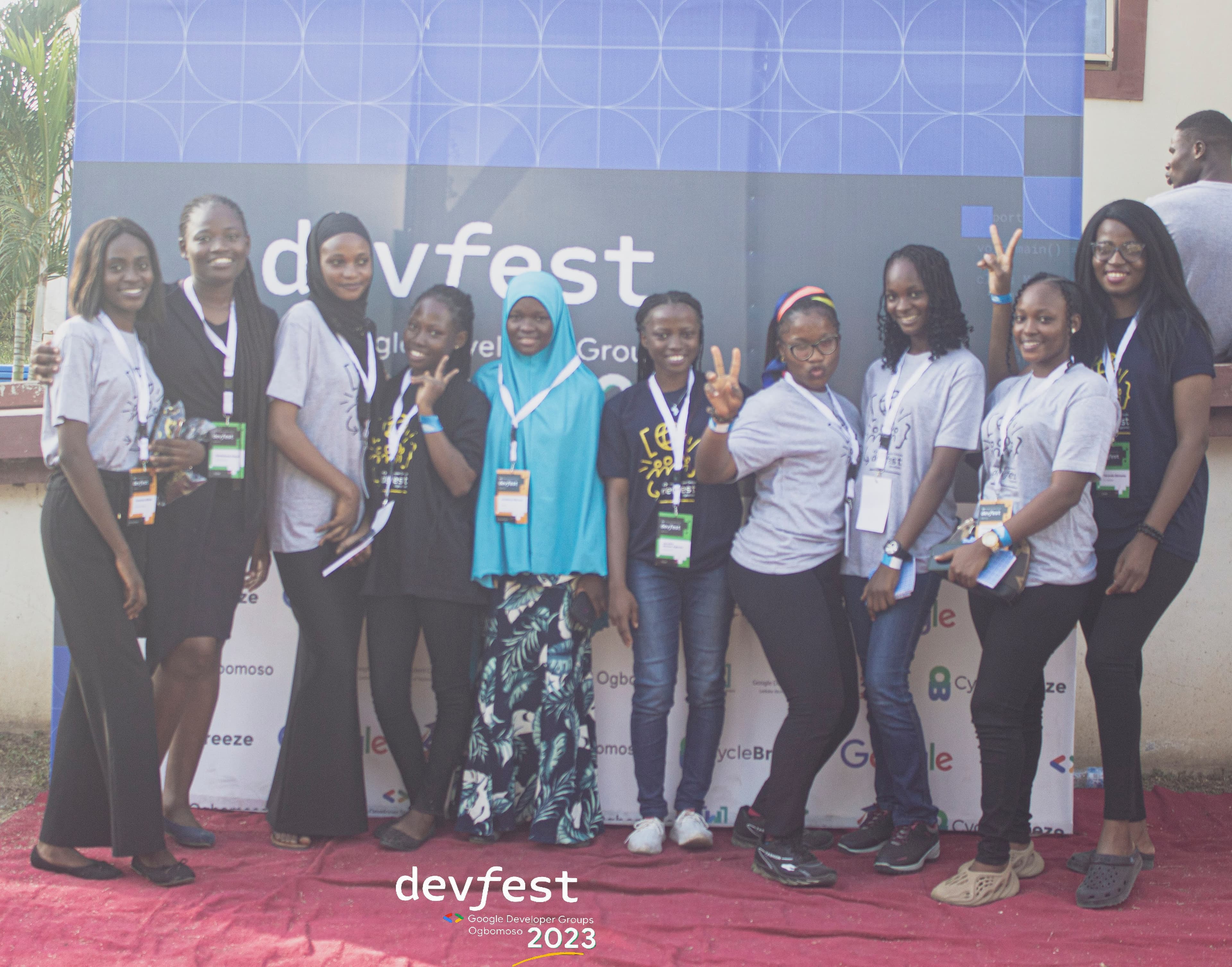 A group of attendees at the photo backdrop at DevFest Ogbomoso 2023