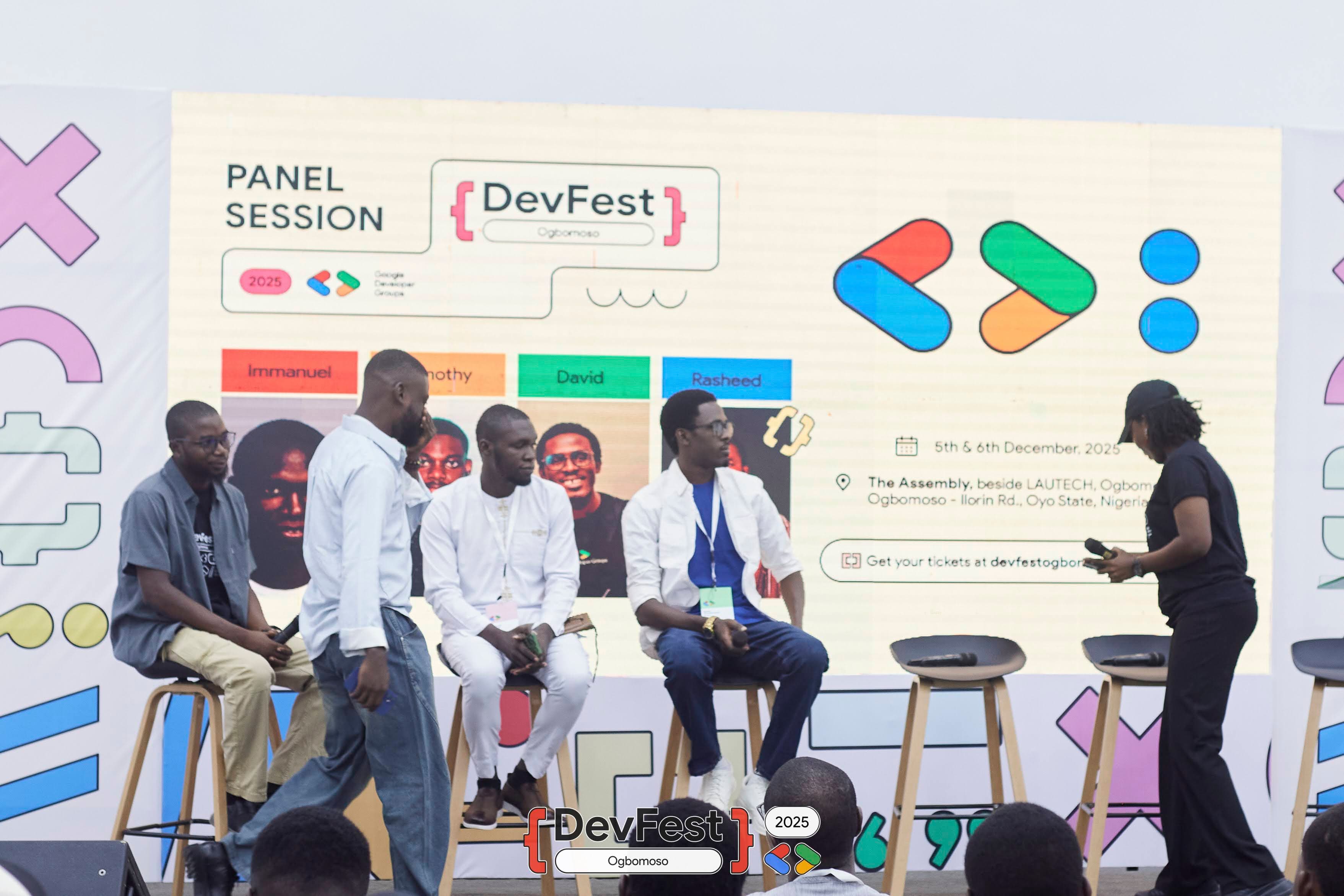 Panelists seated on stage before a panel session slide at DevFest Ogbomoso 2025