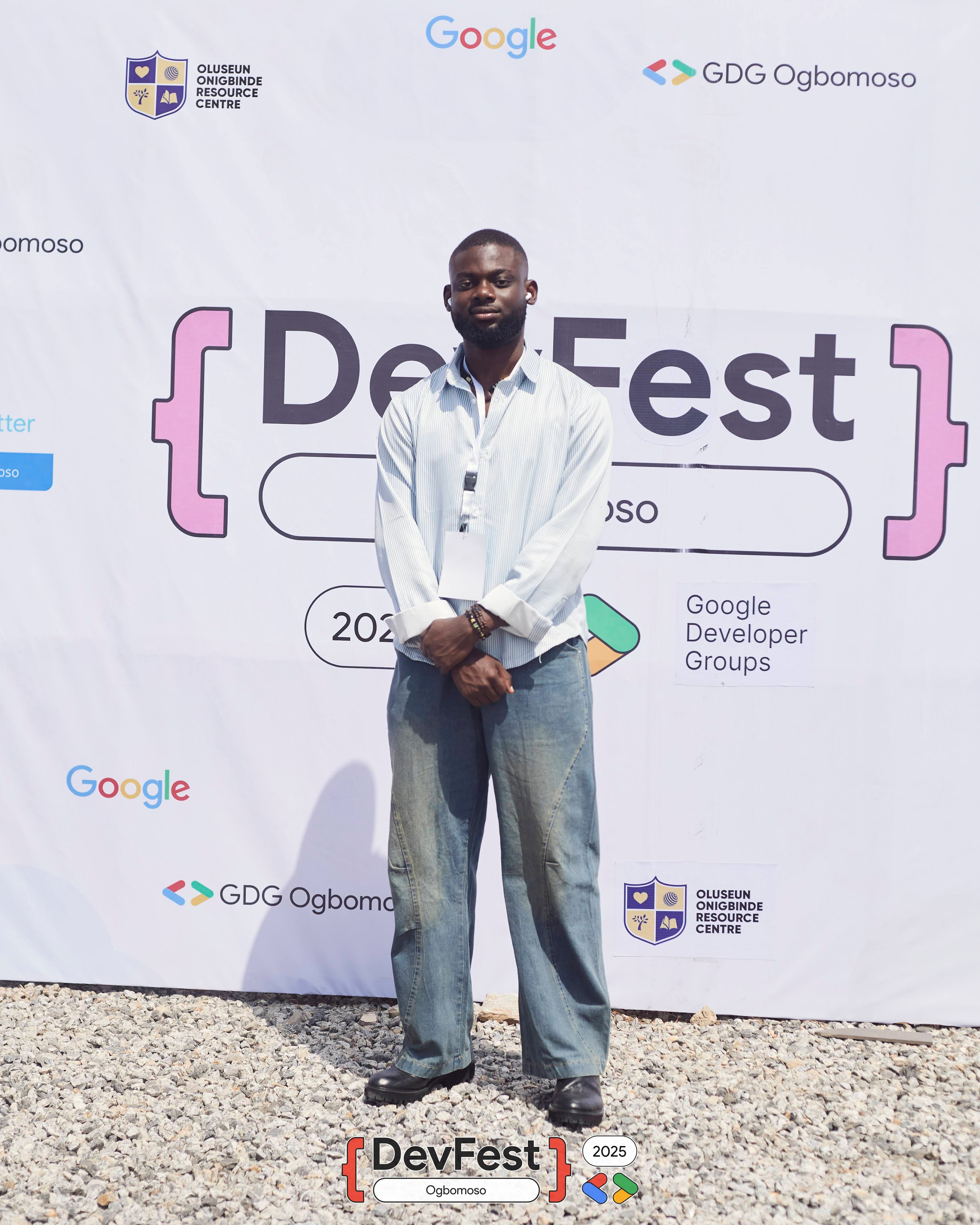 An attendee posing at the DevFest photo area at DevFest Ogbomoso 2025