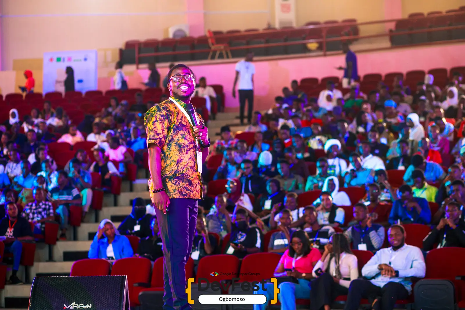 A speaker delivering the keynote to a packed hall